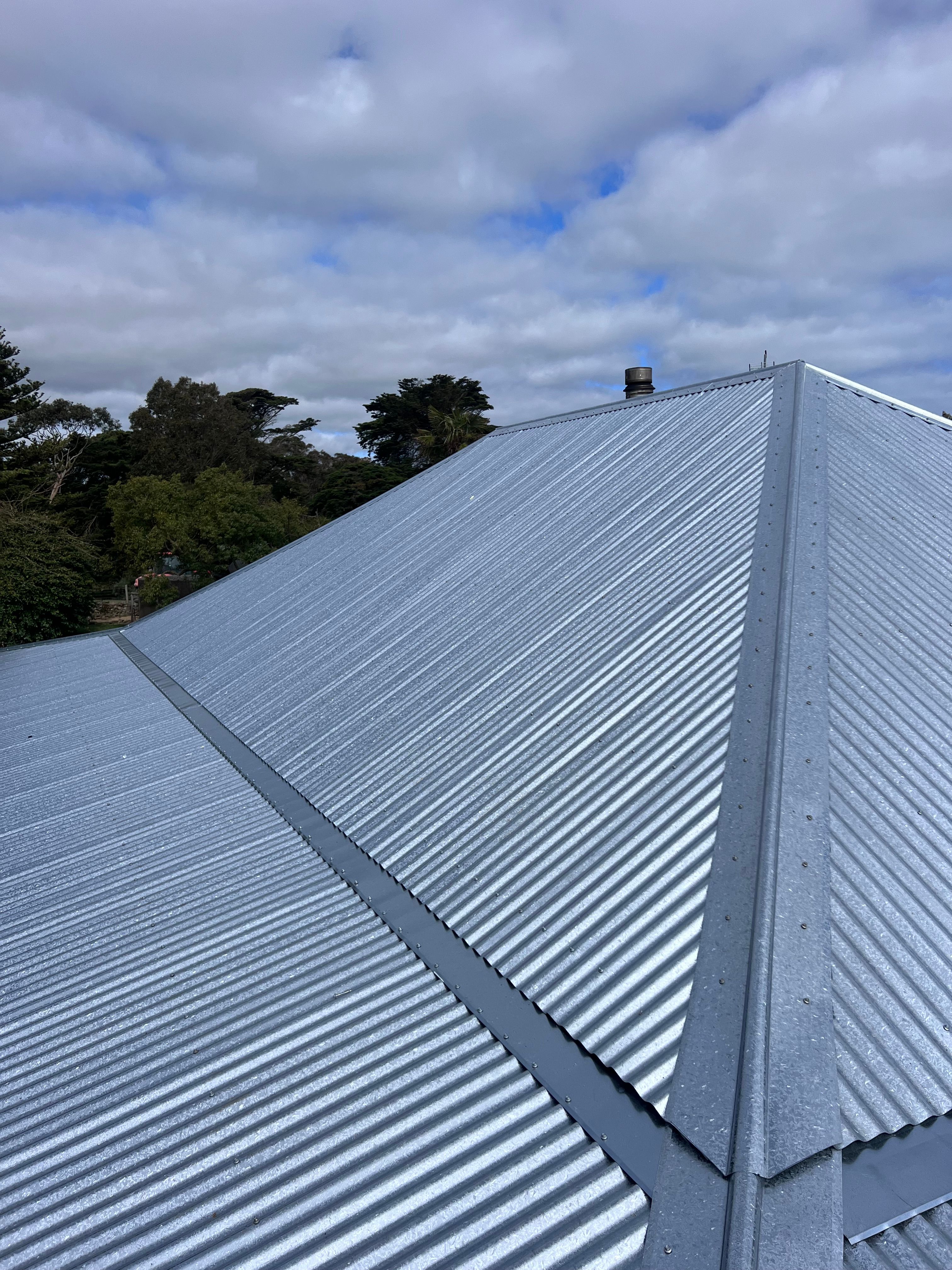 Corrugated metal hip roof with chimney