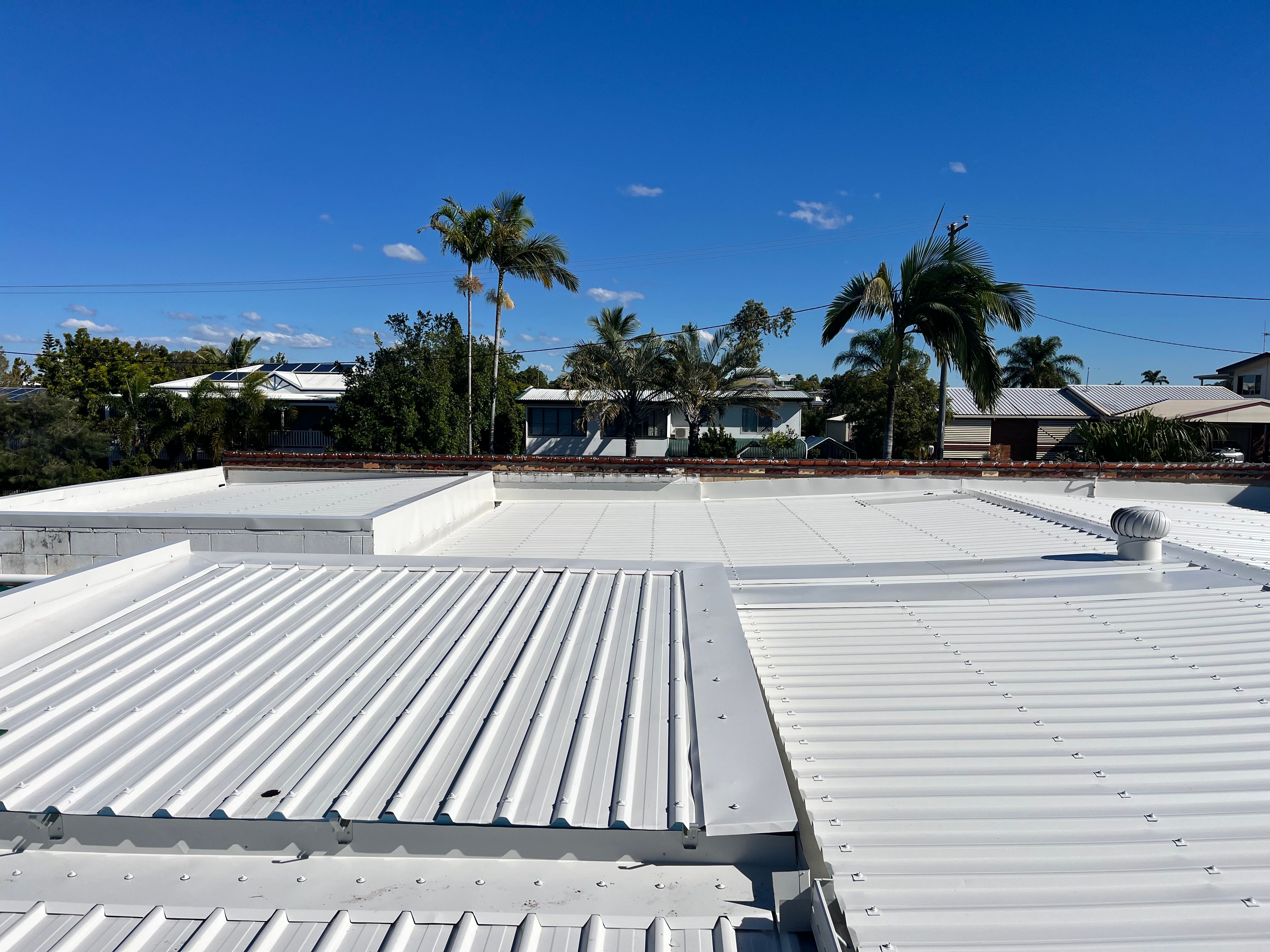 Aerial view of completed white commercial metal roof