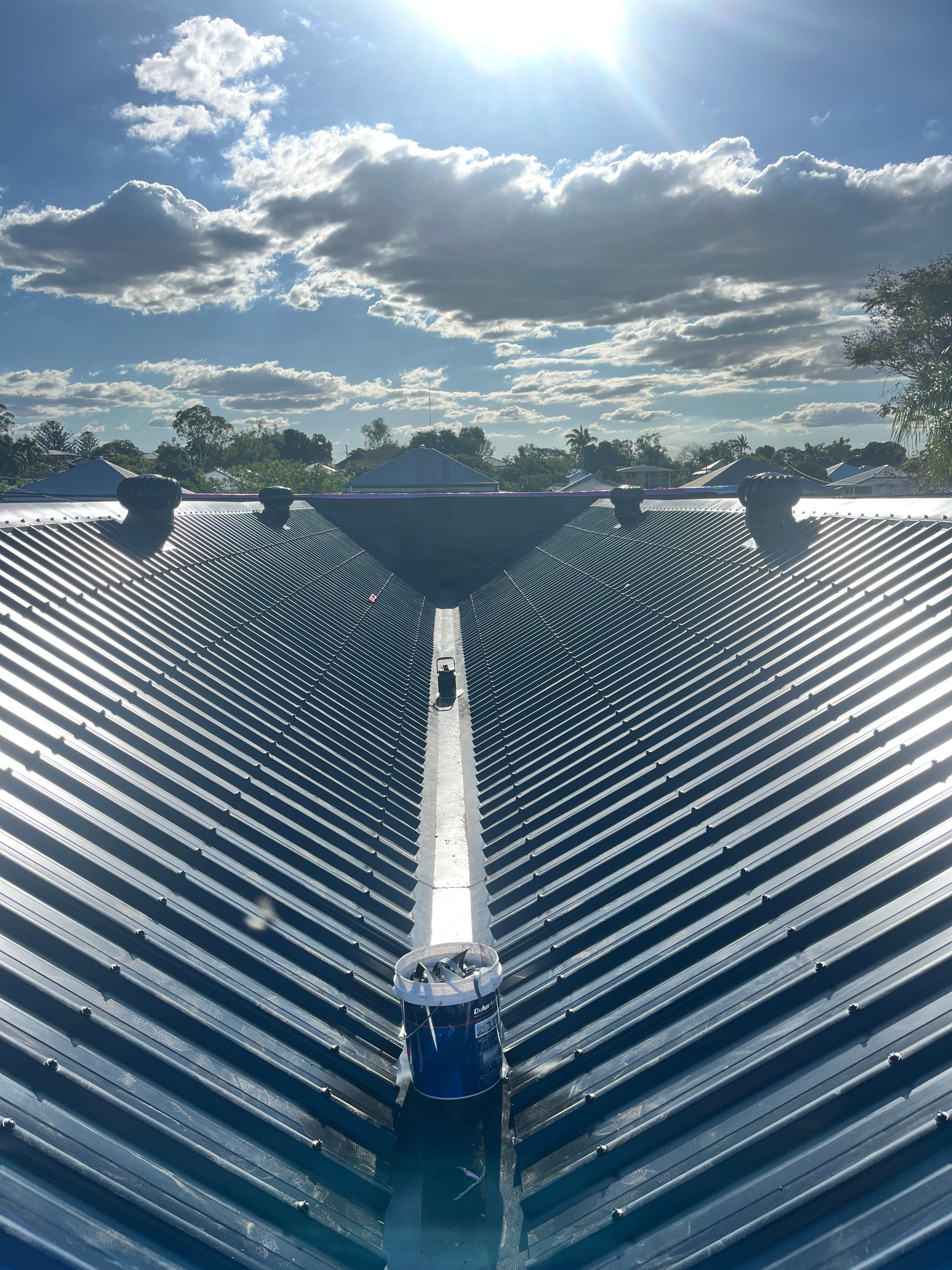 Commercial metal roof from above, dramatic sky