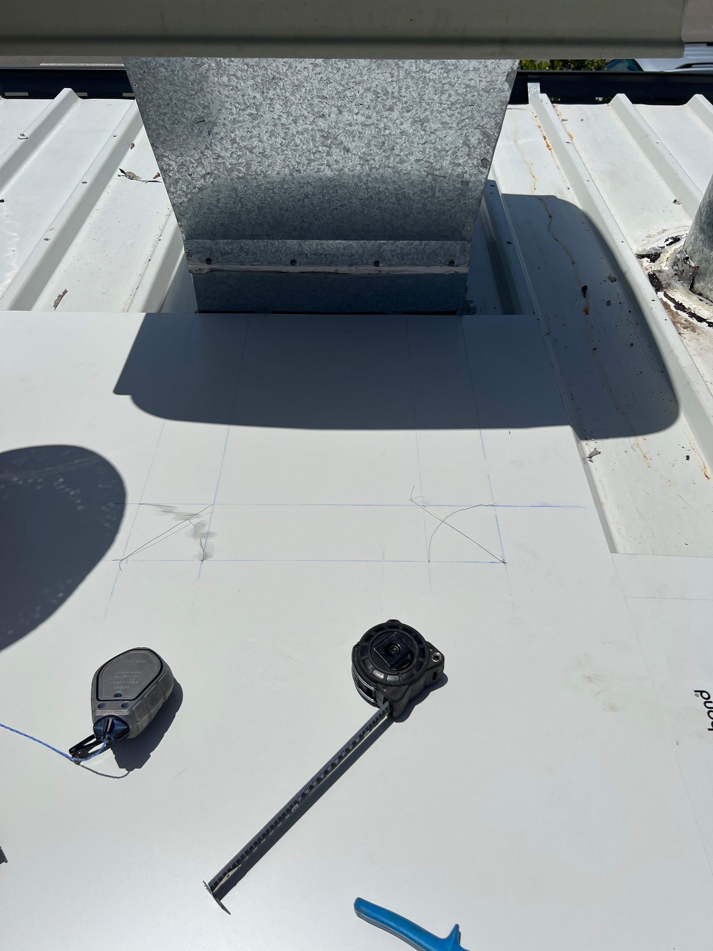 Commercial roof repair — measuring and cutting