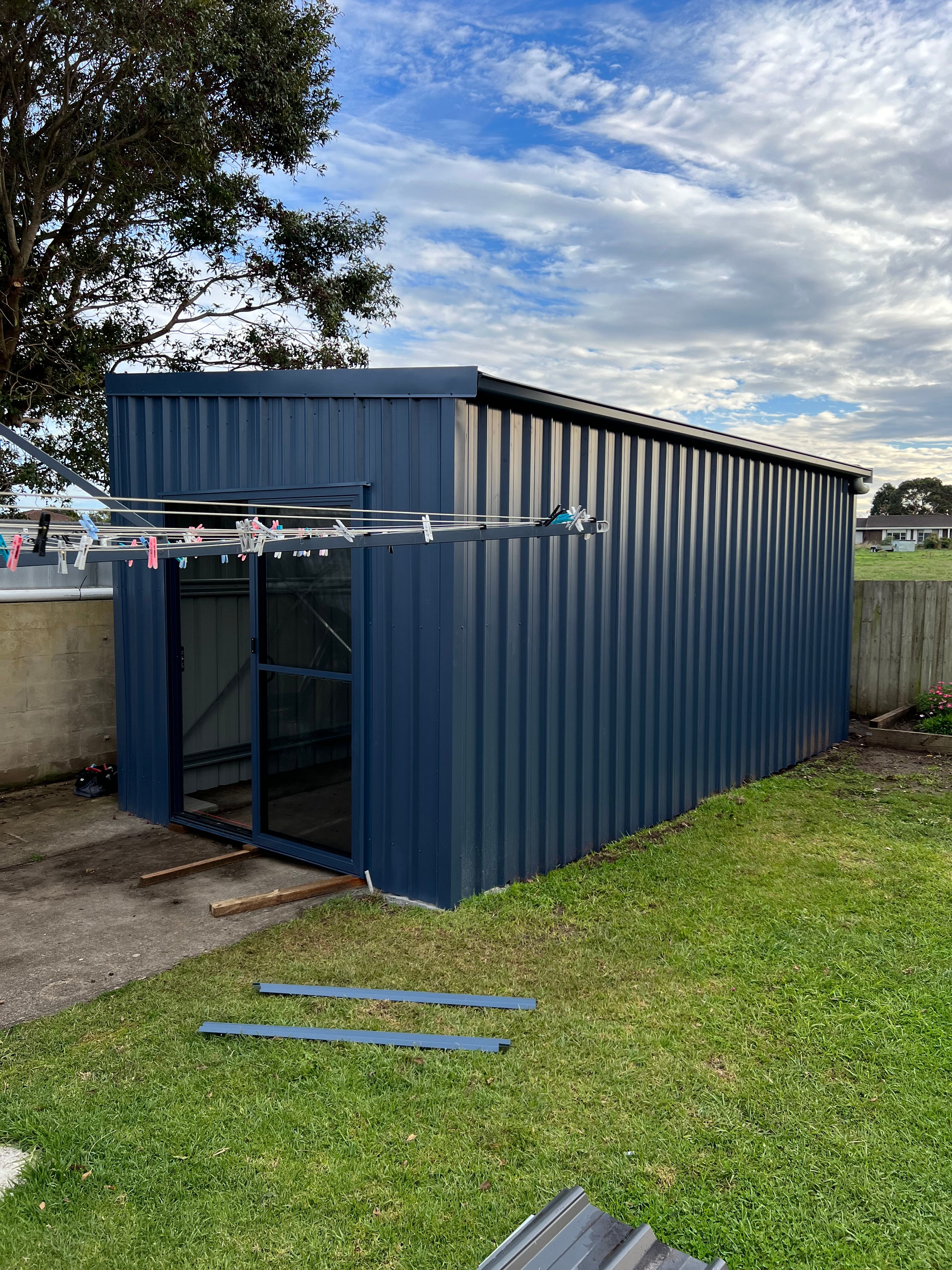 Charcoal blue metal shed — new build