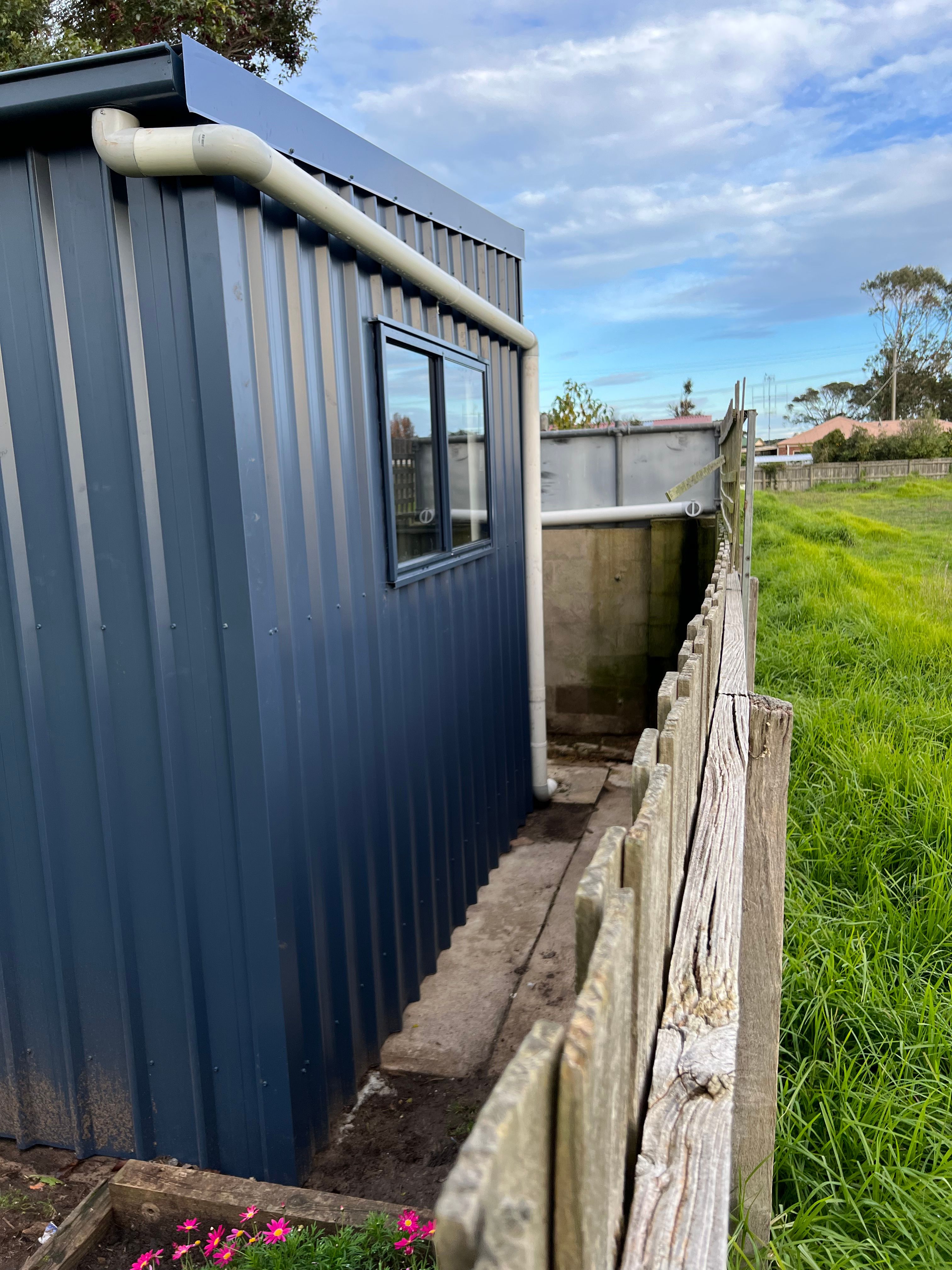 Metal shed cladding with downpipe detail